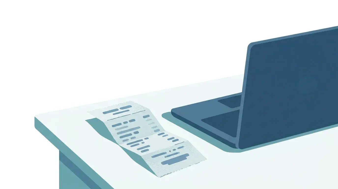 Faded crumpled retail receipt beside a laptop